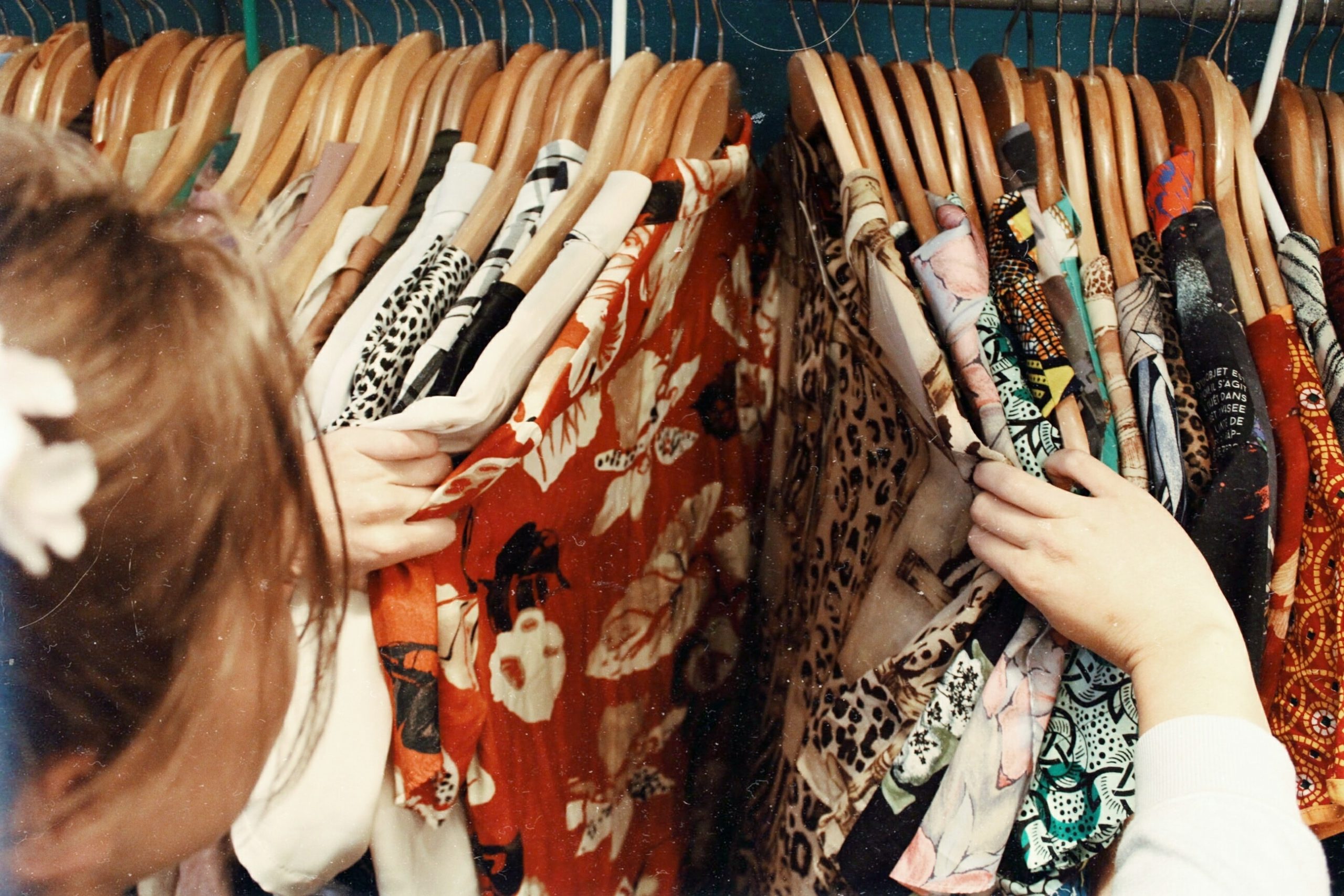 girl-shopping-in-racks-of-clothes