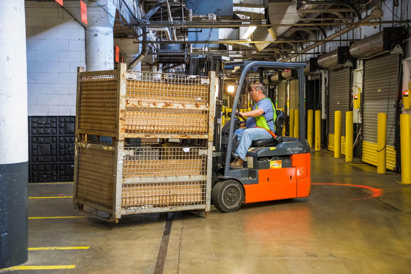 hollingsworth warehouse employee moving product with forkliftx