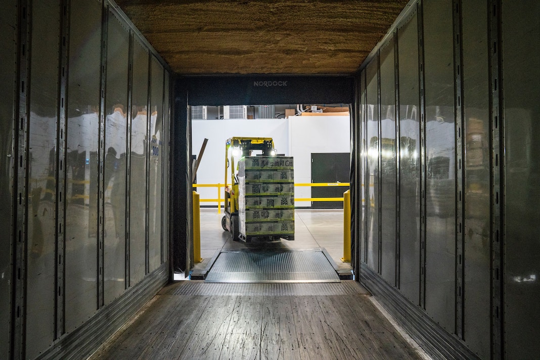 forklift truck loading a cargo container